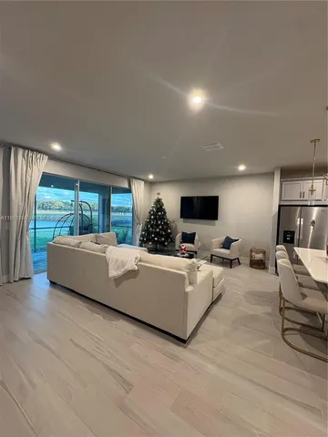 a view of a dining room with furniture and a chandelier