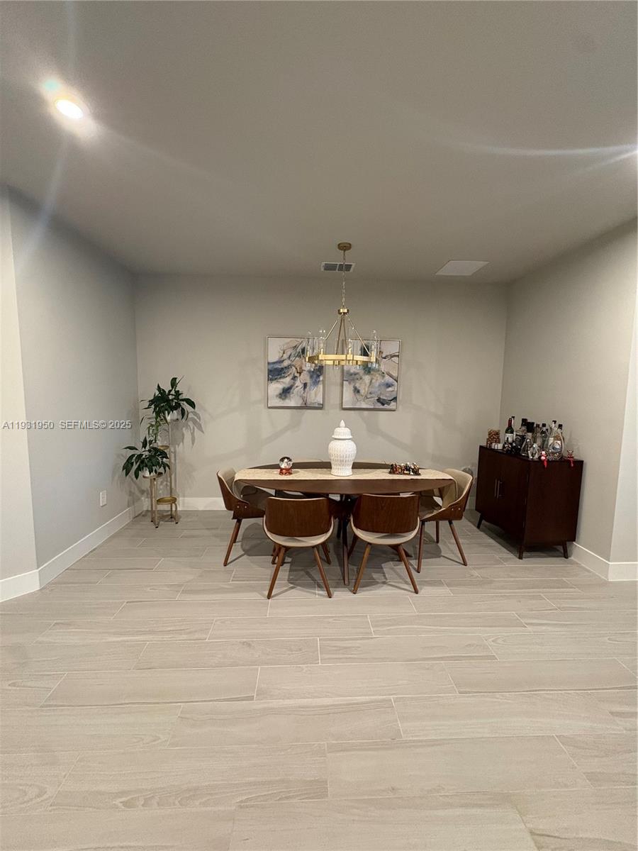 5020 124th Avenue East Parrish, FL 34219 - Photo 15 of 25 a view of a dining room with furniture and a chandelier