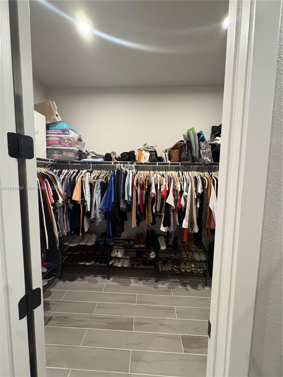 5020 124th Avenue East Parrish, FL 34219 - Photo 18 of 25 a view of walk in closet with clothes and shoes