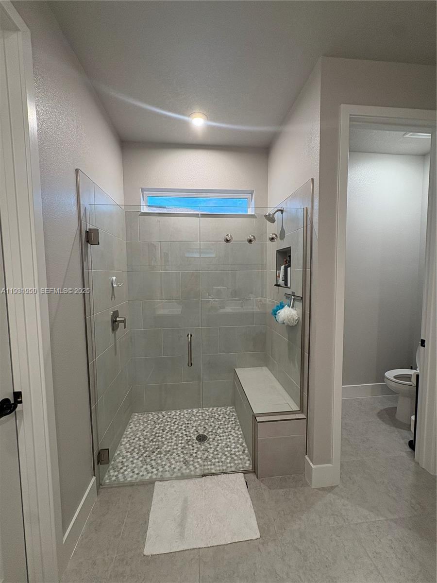 5020 124th Avenue East Parrish, FL 34219 - Photo 19 of 25 a bathroom with a shower and a toilet