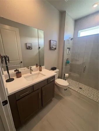 a white toilet sitting next to a sink