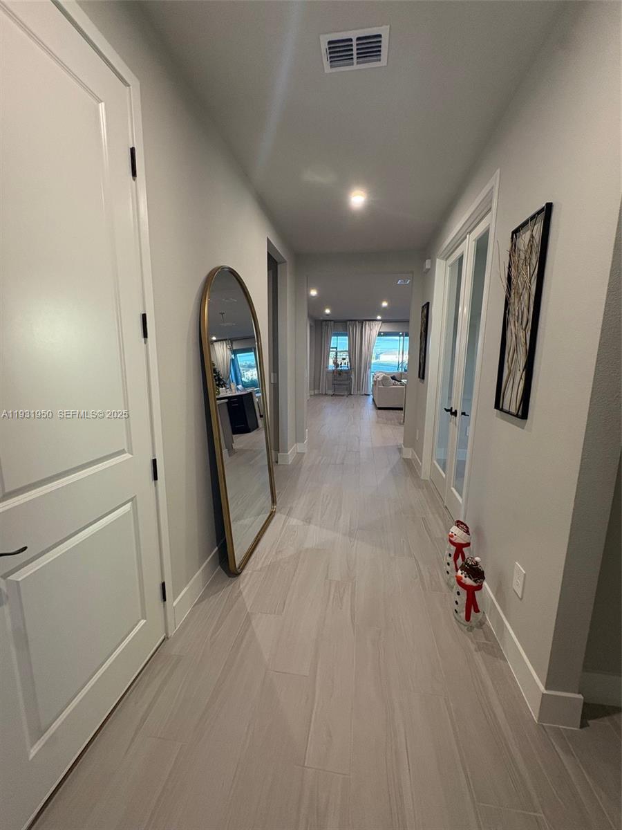 5020 124th Avenue East Parrish, FL 34219 - Photo 4 of 25 a view of a hallway with wooden floor and stairs