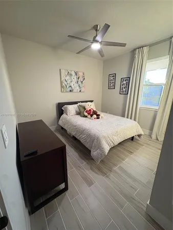 a kitchen with stainless steel appliances kitchen island granite countertop a sink a stove a refrigerator cabinets and chairs