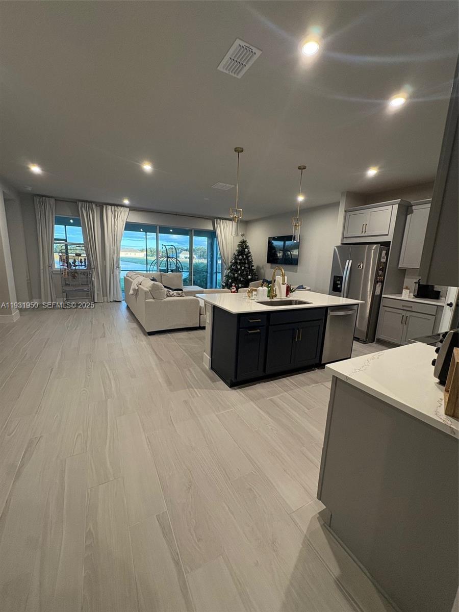5020 124th Avenue East Parrish, FL 34219 - Photo 10 of 25 a large white kitchen with lots of counter space