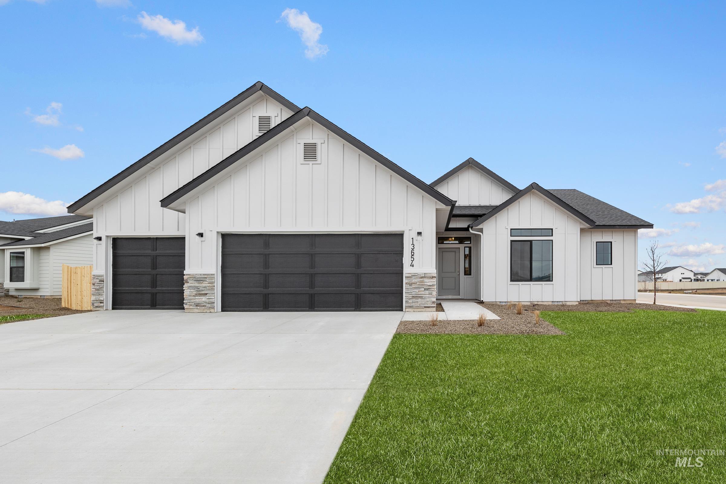 13654 Inman Court Caldwell, ID 83607 - Photo 1 of 25 Modern inspired farmhouse with board and batten siding, concrete driveway, an attached garage, a front lawn, and roof with shingles