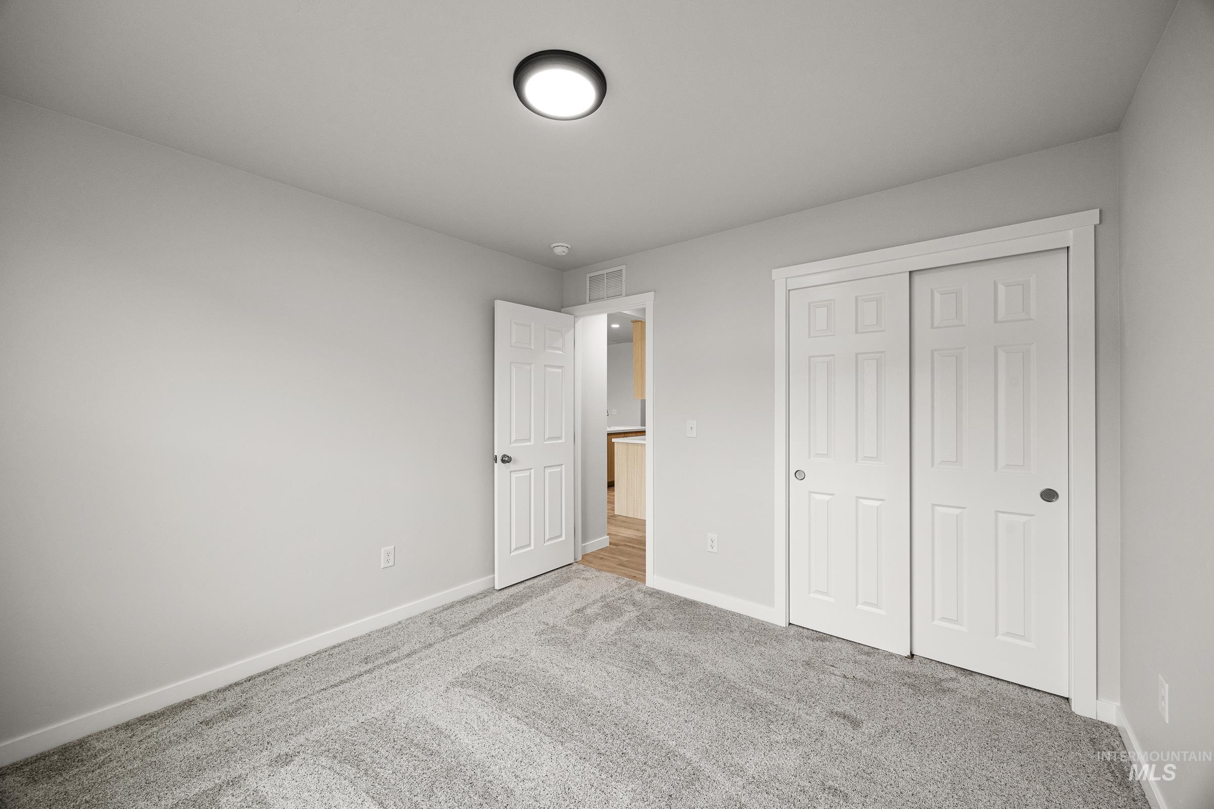 13654 Inman Court Caldwell, ID 83607 - Photo 12 of 25 Unfurnished bedroom with carpet flooring and a closet
