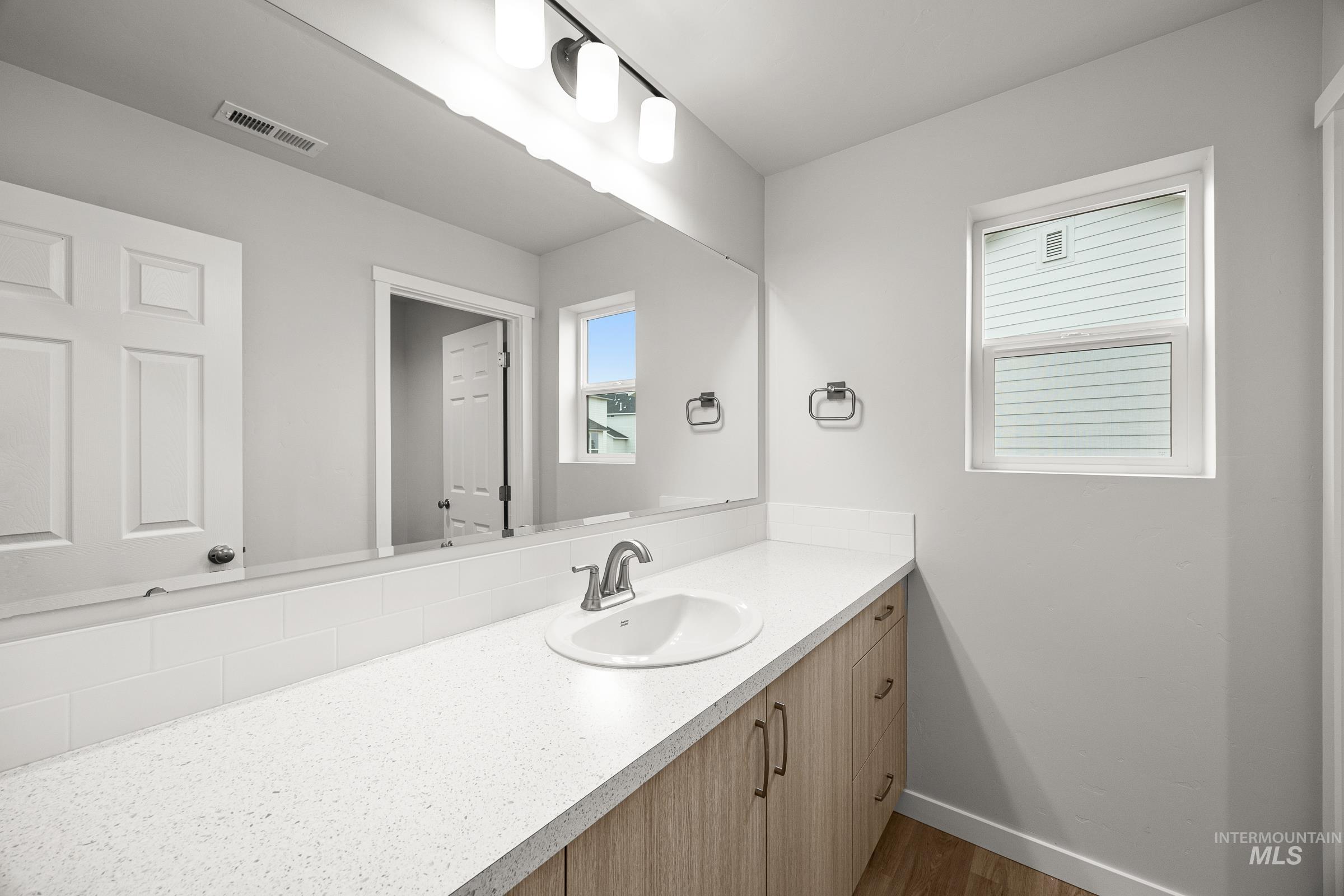 13654 Inman Court Caldwell, ID 83607 - Photo 13 of 25 Bathroom with vanity and dark wood-type flooring