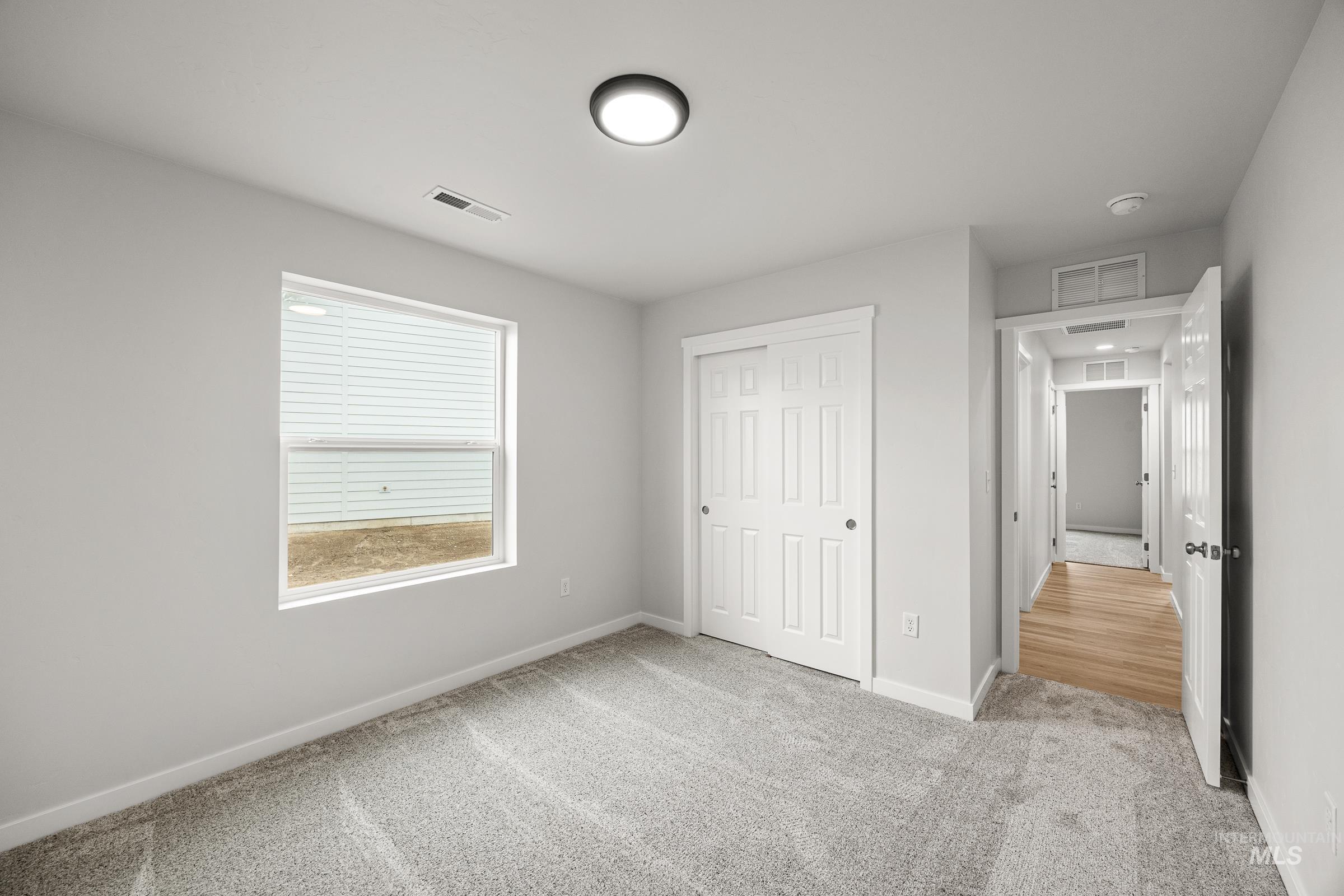 13654 Inman Court Caldwell, ID 83607 - Photo 16 of 25 Unfurnished bedroom with light carpet and a closet