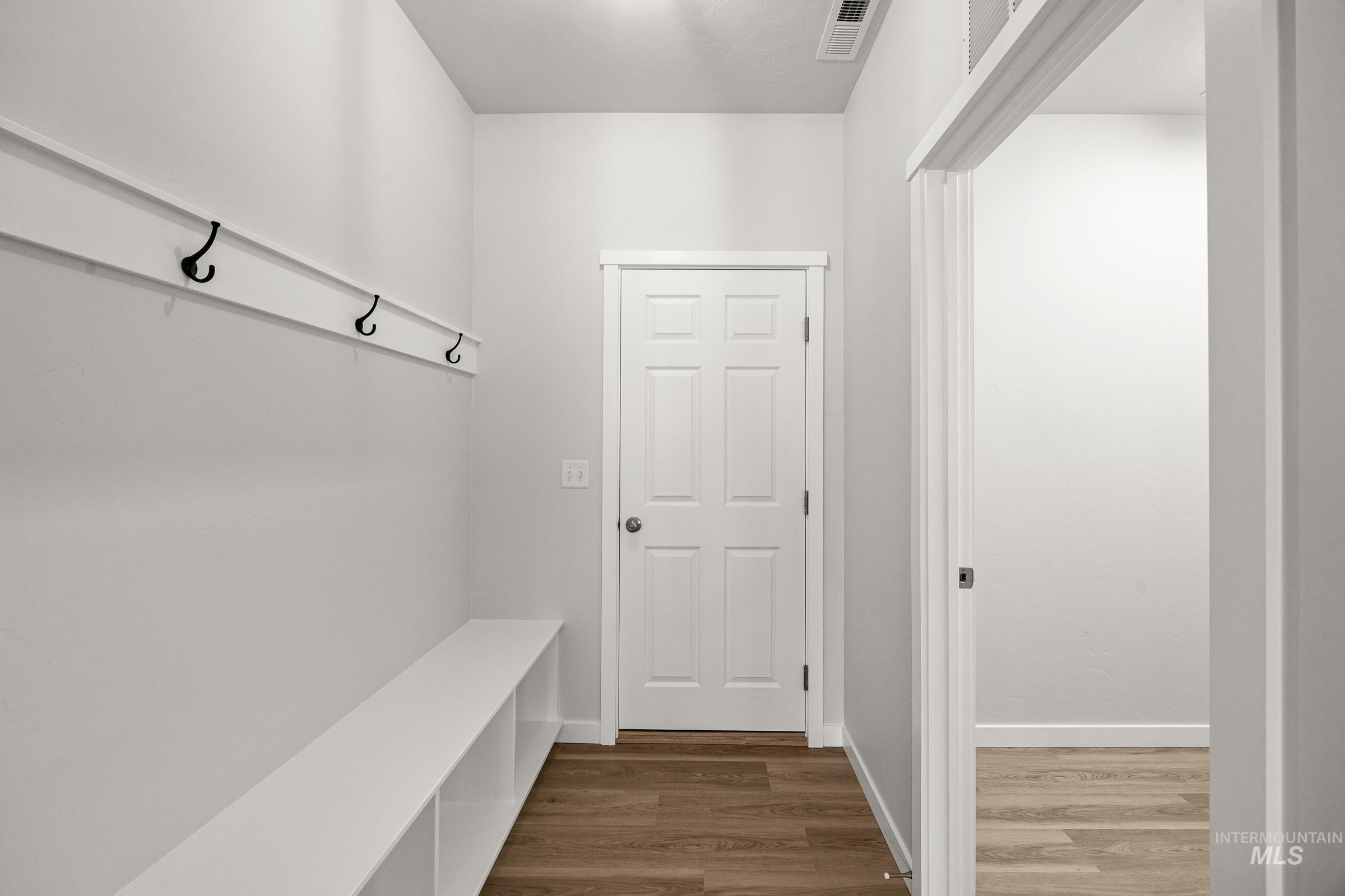 13654 Inman Court Caldwell, ID 83607 - Photo 17 of 25 Mudroom featuring dark wood finished floors and baseboards