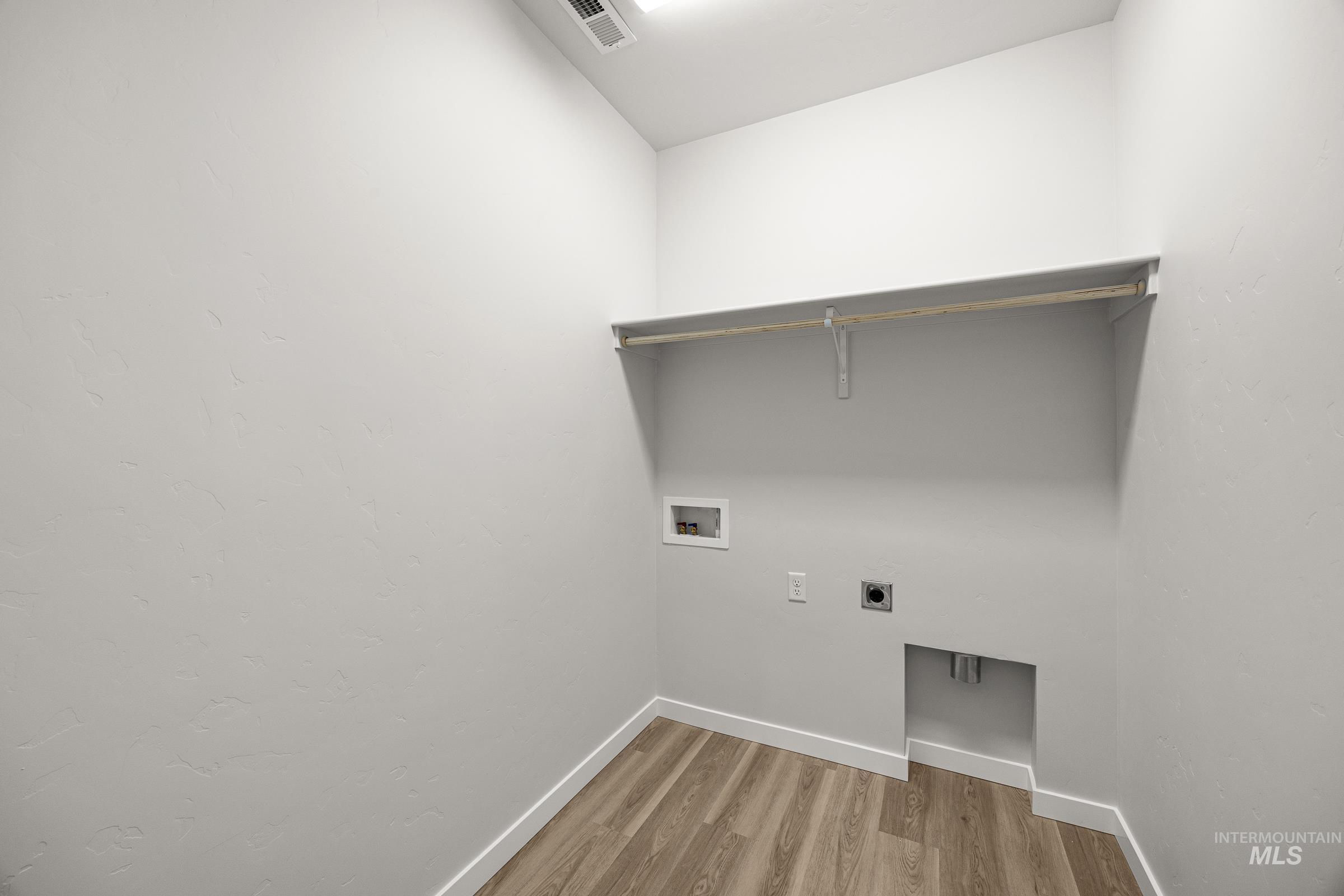 13654 Inman Court Caldwell, ID 83607 - Photo 18 of 25 Laundry room featuring light wood-type flooring, electric dryer hookup, and hookup for a washing machine
