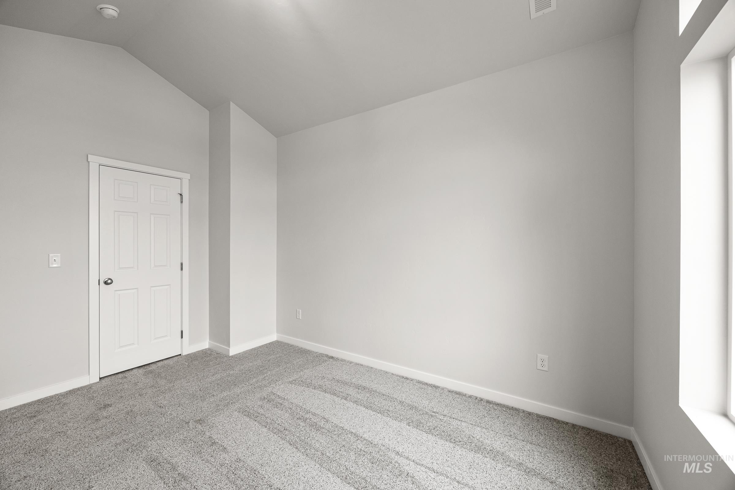 13654 Inman Court Caldwell, ID 83607 - Photo 25 of 25 Spare room featuring carpet floors and lofted ceiling