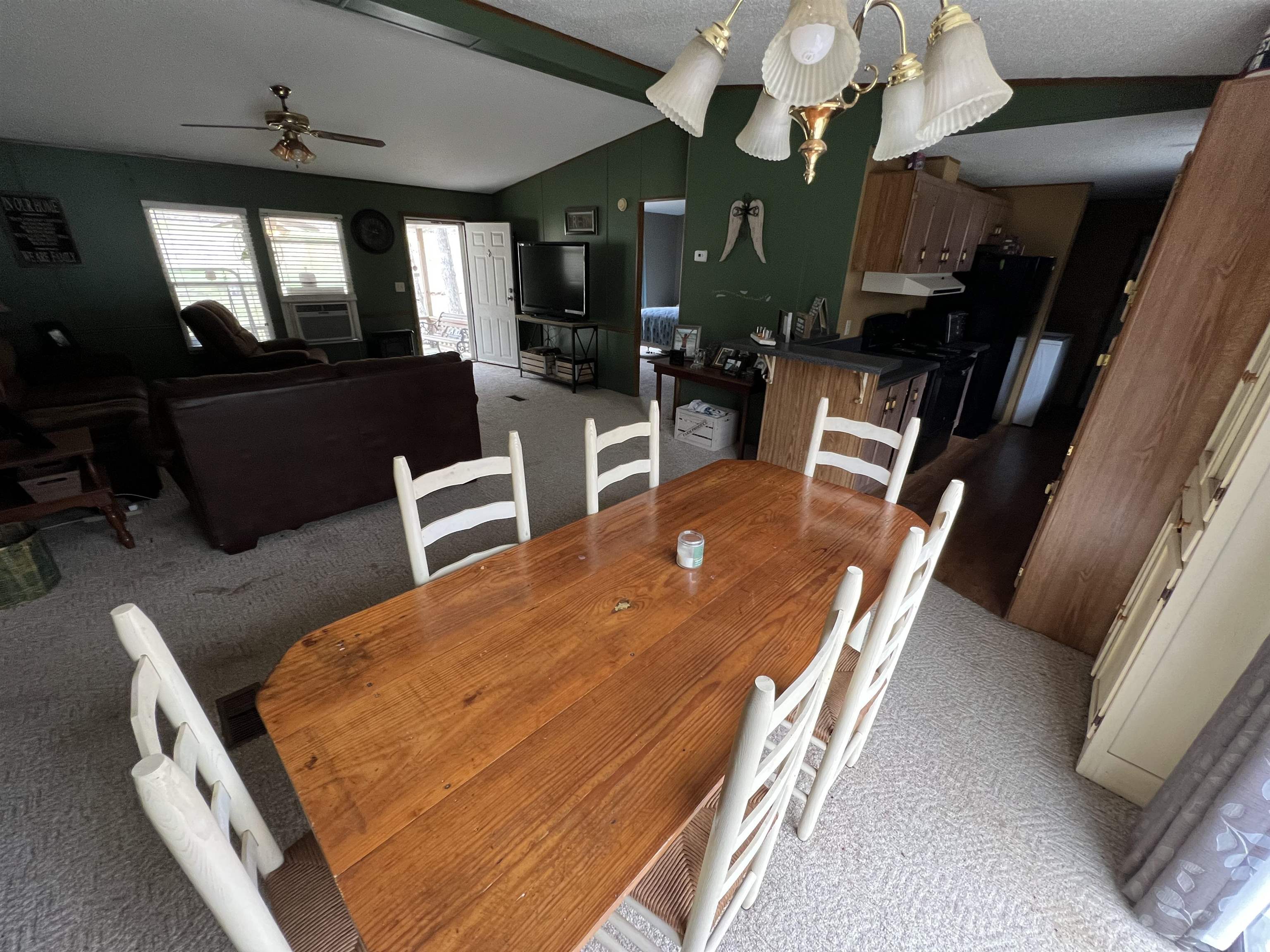 1405 Bruton Branch Road Savannah, TN 38372 - Photo 11 of 20 Dining space with lofted ceiling with beams, a textured ceiling, a ceiling fan, carpet floors, and cooling unit
