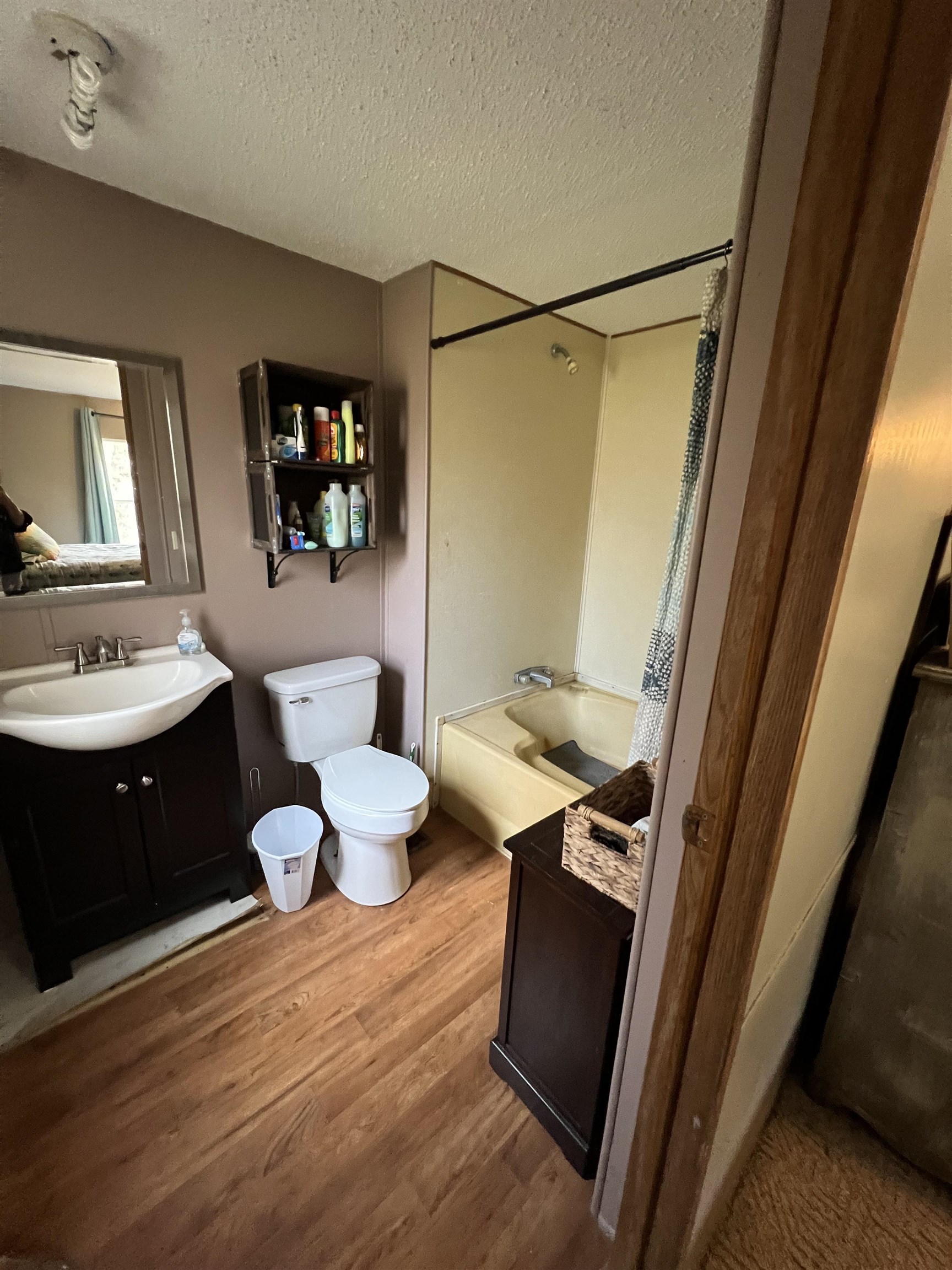 1405 Bruton Branch Road Savannah, TN 38372 - Photo 14 of 20 Full bath featuring shower combination, toilet, a textured ceiling, and wood finished floors