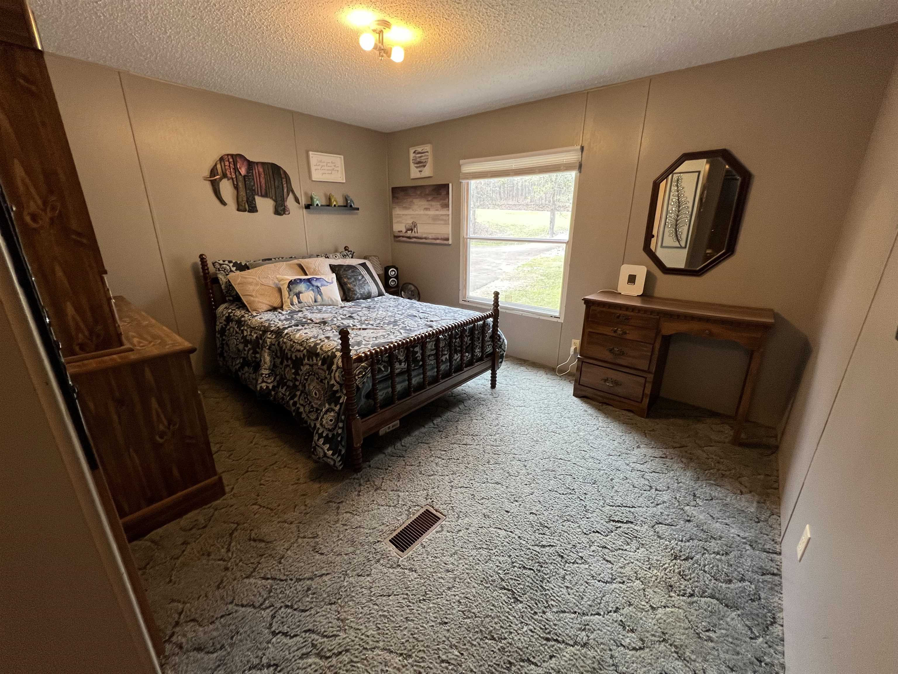 1405 Bruton Branch Road Savannah, TN 38372 - Photo 15 of 20 Bedroom with carpet flooring, a textured ceiling, and visible vents
