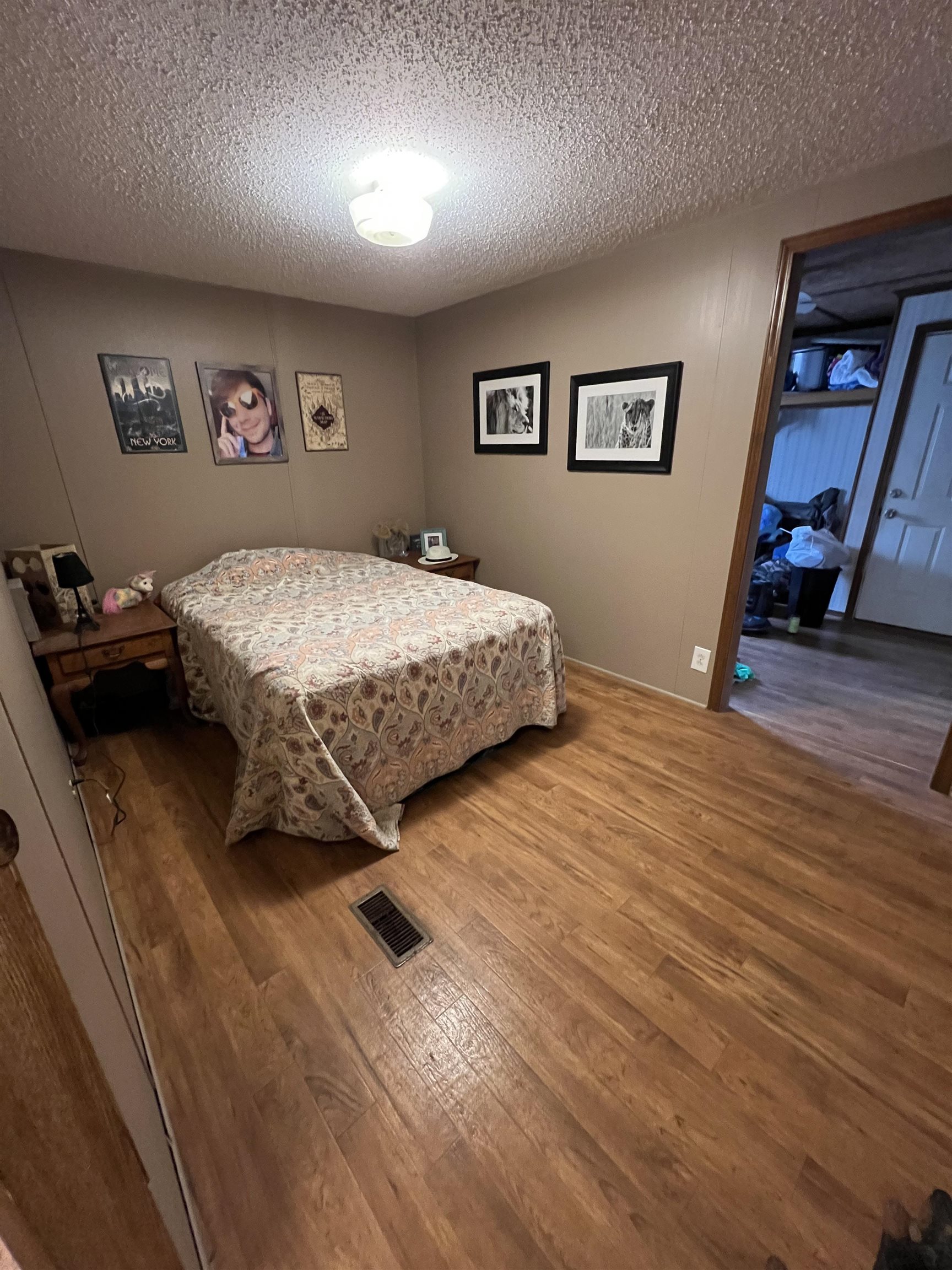 1405 Bruton Branch Road Savannah, TN 38372 - Photo 16 of 20 Bedroom featuring wood finished floors, a textured ceiling, and visible vents
