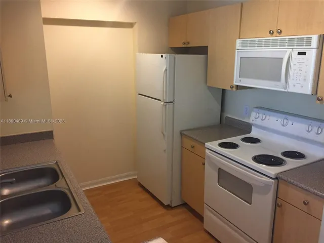 a kitchen with a stove and a refrigerator