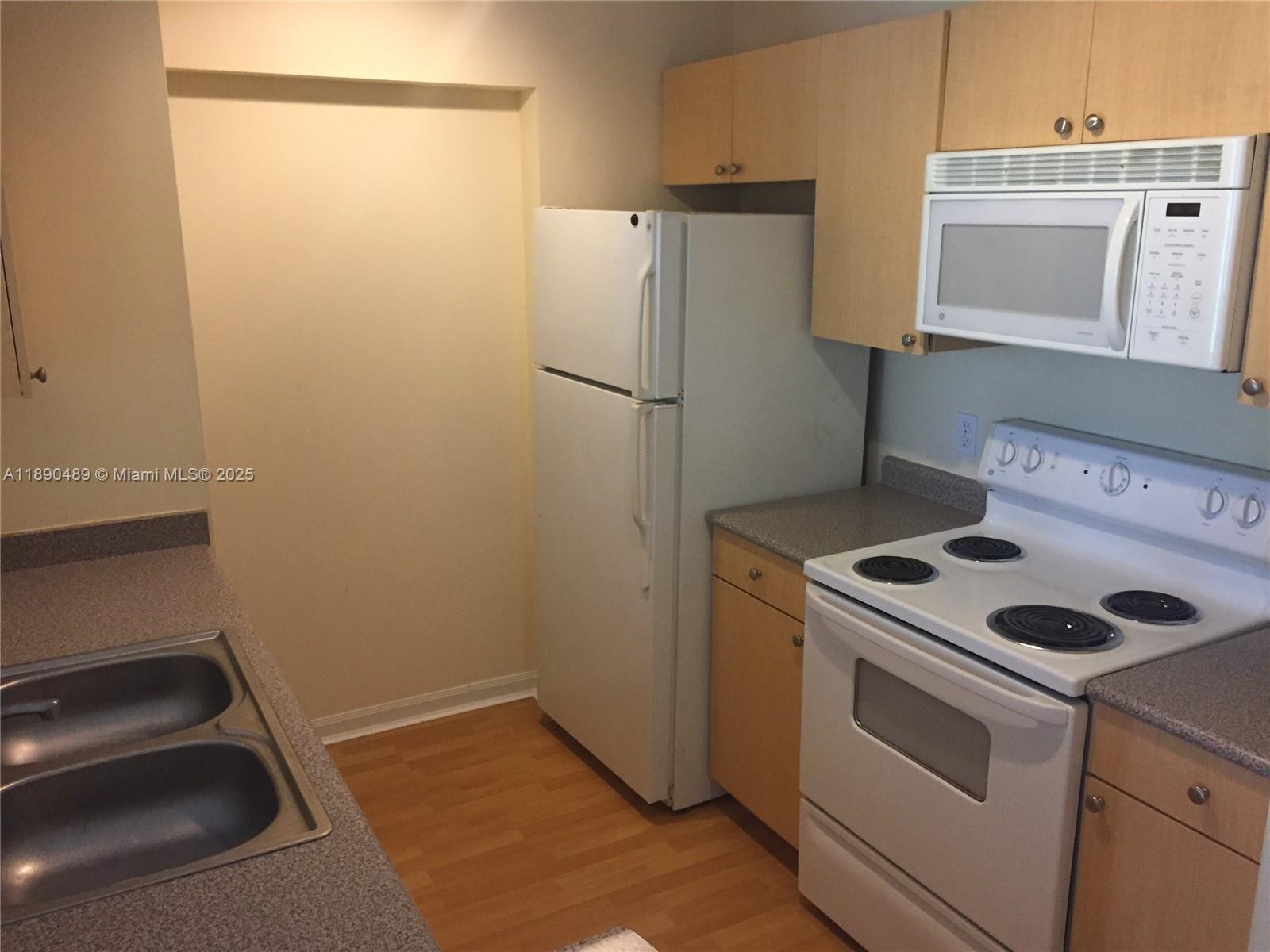 1919 Van Buren Street, Unit 416A Hollywood, FL 33020 - Photo 5 of 17 a kitchen with a stove and a refrigerator