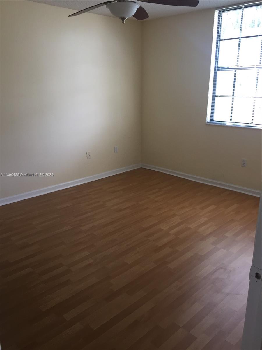 1919 Van Buren Street, Unit 416A Hollywood, FL 33020 - Photo 6 of 17 wooden floor in an empty room