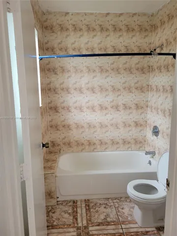 a bathroom with a shower and a toilet