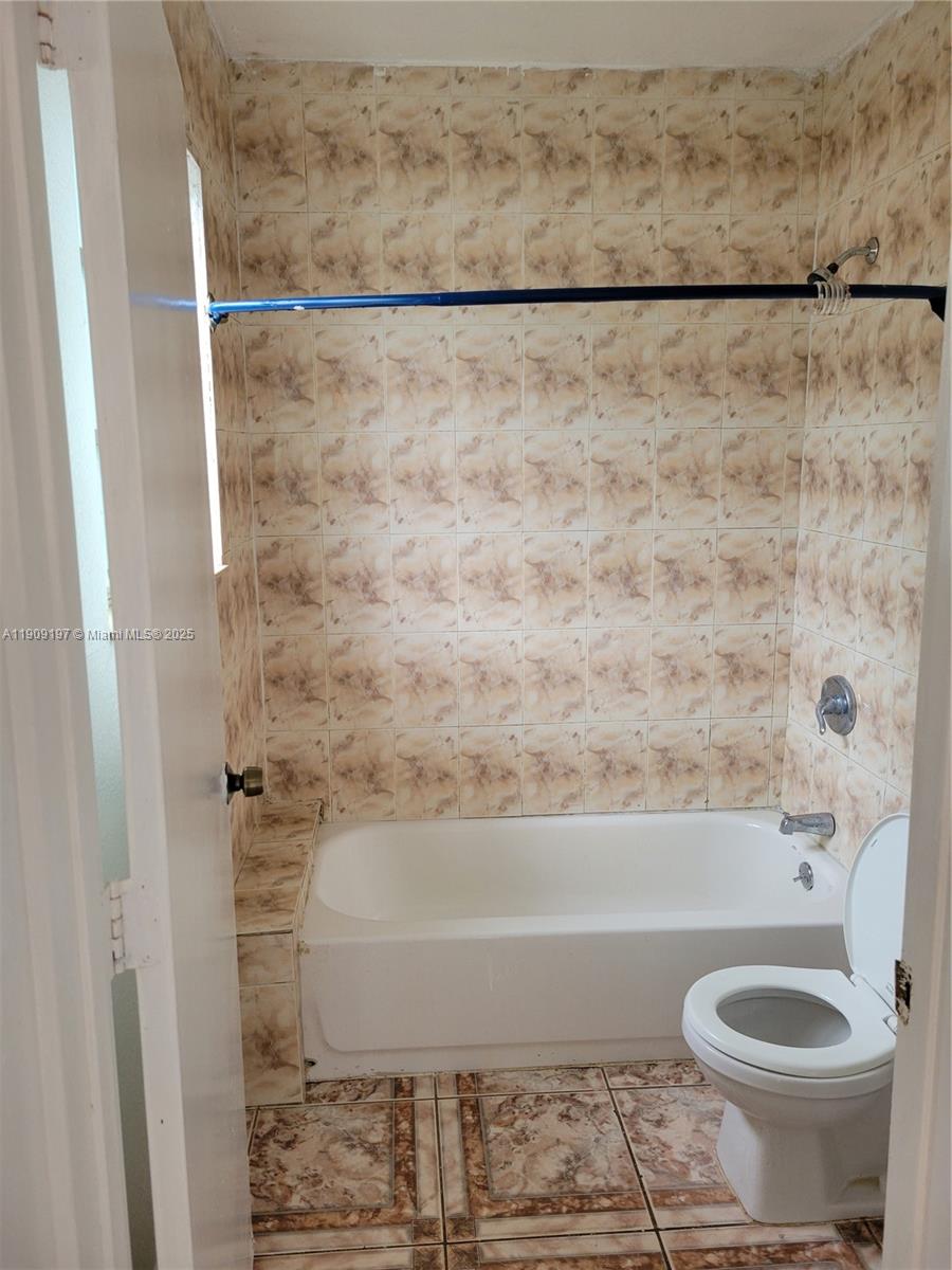 14815 Northeast 8th Court, Unit 1 Miami, FL 33161 - Photo 2 of 6 a bathroom with a shower and a toilet