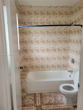 a bathroom with a shower and a toilet