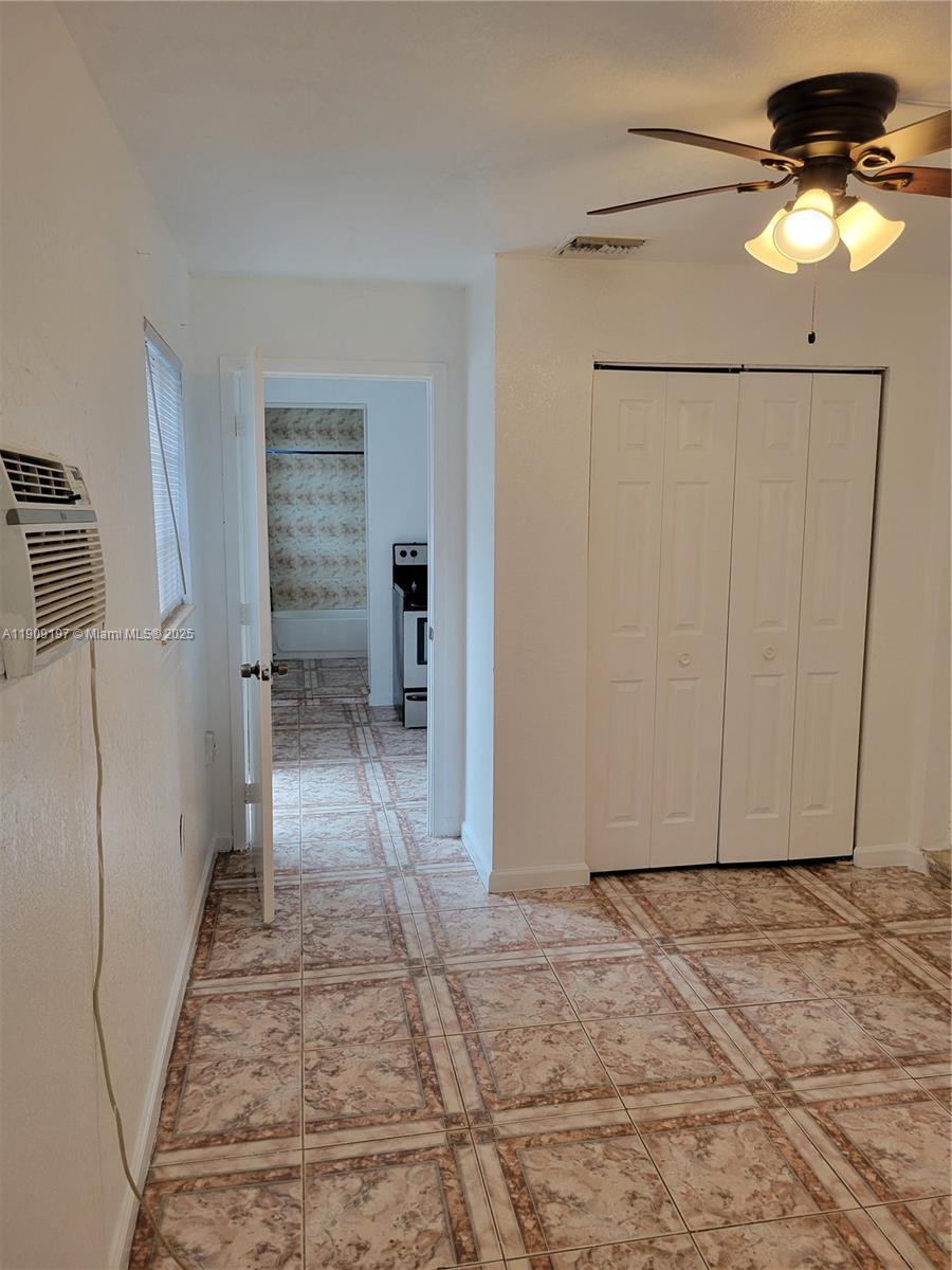 14815 Northeast 8th Court, Unit 1 Miami, FL 33161 - Photo 3 of 6 a view of a hallway with a chandelier