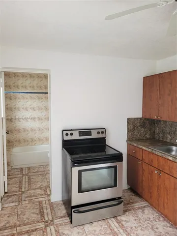 a kitchen with granite countertop a stove and a microwave