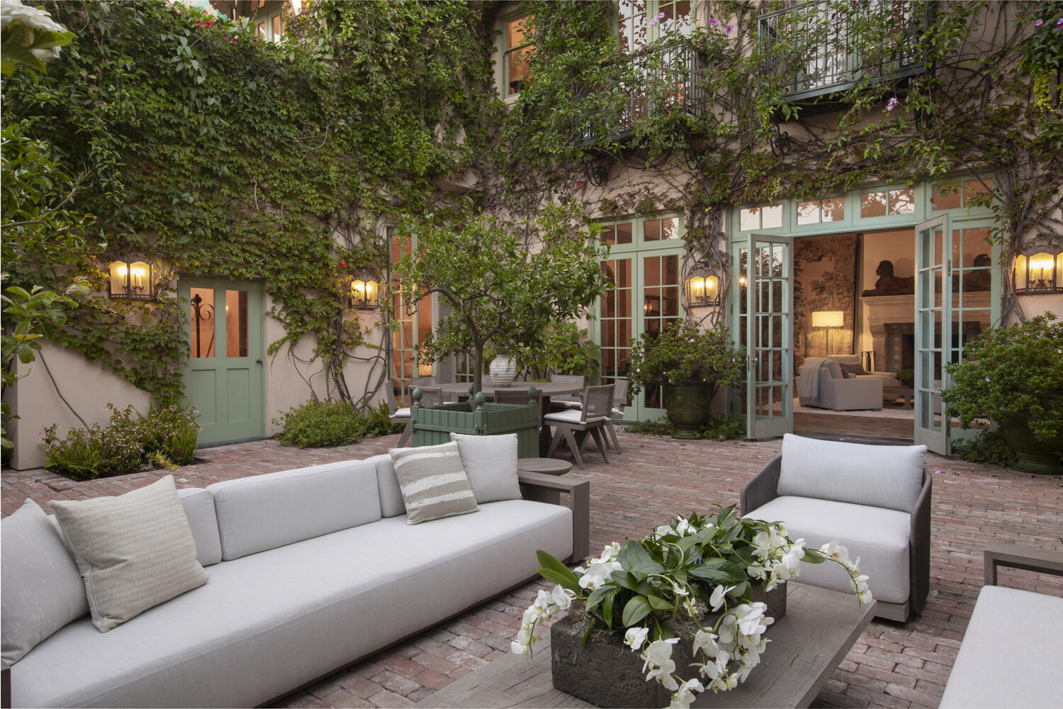 670 Hot Springs Road Montecito, CA 93108 - Photo 14 of 23 a view of a patio with couches and a fire pit and large trees