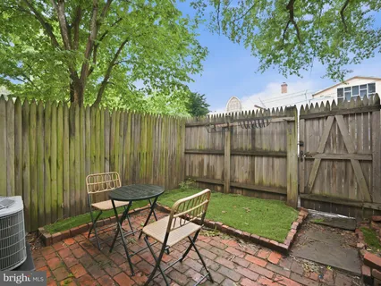 a view of a chairs and table in backyard of the house