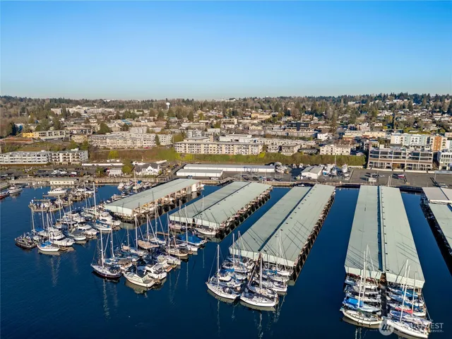 a living room with furniture large window and wooden floor