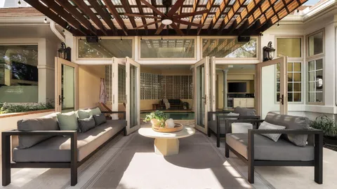 a view of a house with backyard porch and sitting area