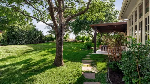 a backyard of a house with a yard and outdoor seating