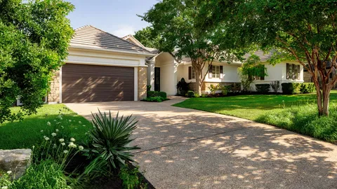 a front view of a house with parking area