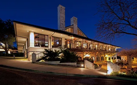 a view of a balcony with chairs and wooden floor