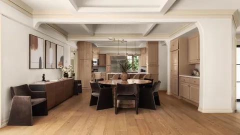 a room with stainless steel appliances kitchen island granite countertop a table chairs in it and wooden floors