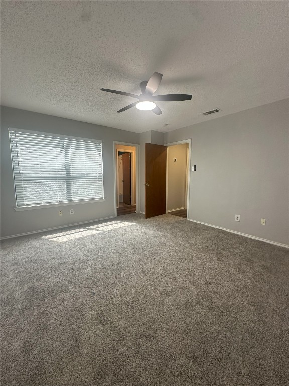 7800 Chimayo Cove, Unit B Austin, TX 78729 - Photo 12 of 17 a view of an empty room with window and chandelier fan