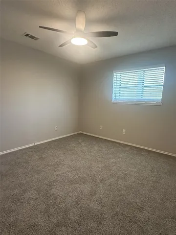 an empty room with a empty space and a ceiling fan