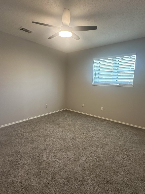 7800 Chimayo Cove, Unit B Austin, TX 78729 - Photo 15 of 17 an empty room with a empty space and a ceiling fan