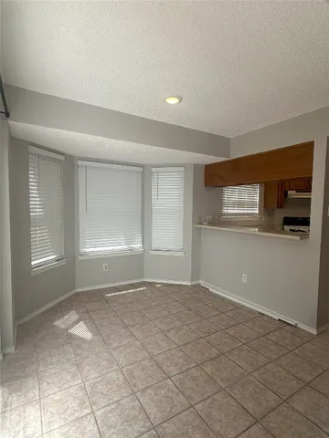 a view of wooden floor and windows in a room