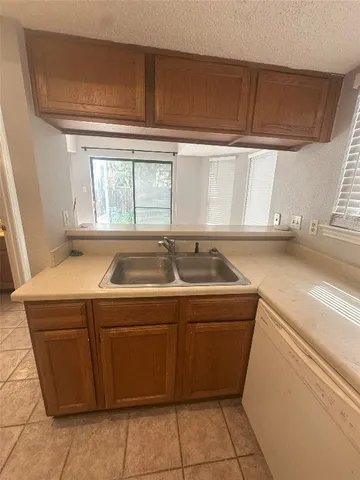a utility room with a sink washer and dryer