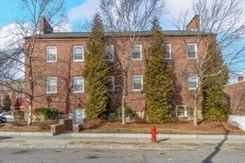 a view of a brick building next to a yard