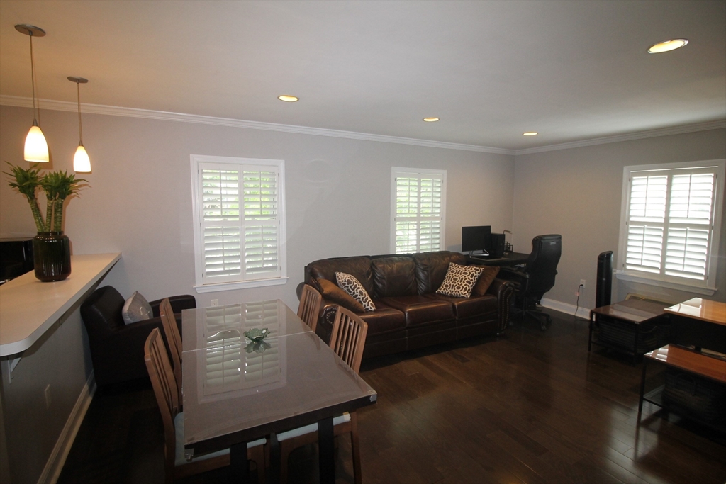 27 Commonwealth Avenue, Unit 1 Newton, MA 02467 - Photo 2 of 12 a living room with furniture and a window