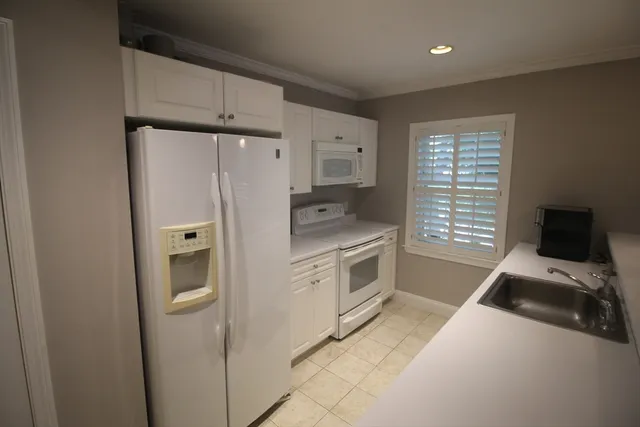 a kitchen with a refrigerator stove and a sink