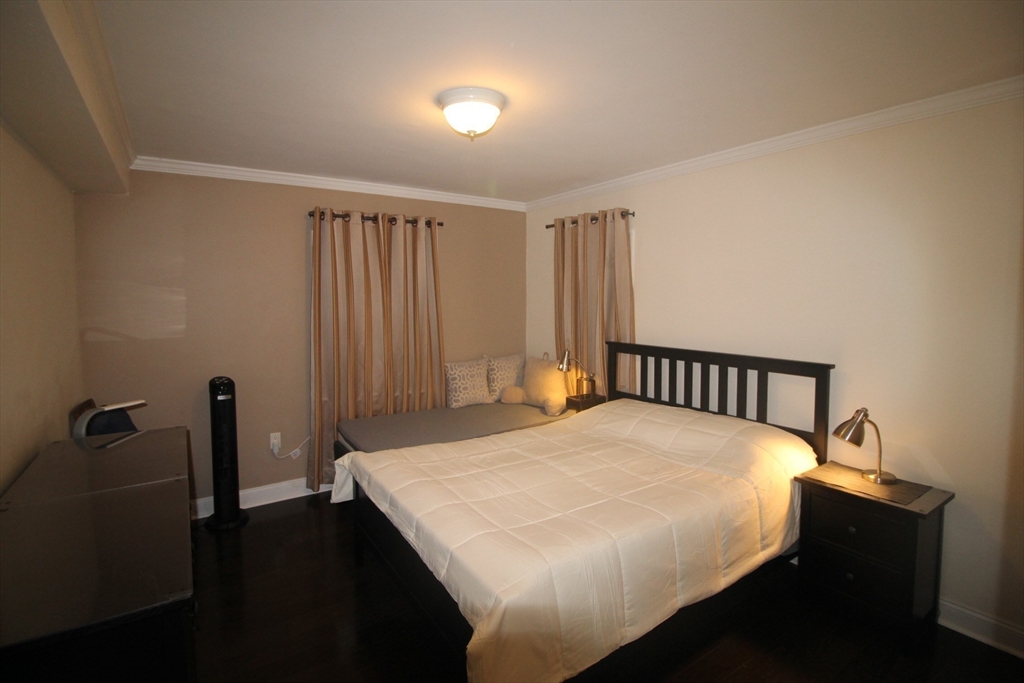 27 Commonwealth Avenue, Unit 1 Newton, MA 02467 - Photo 4 of 12 a large bed sitting in a bedroom next to a window