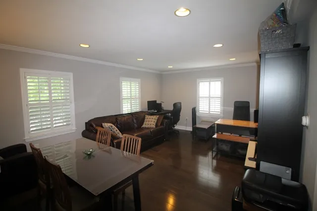 a living room with furniture and wooden floor