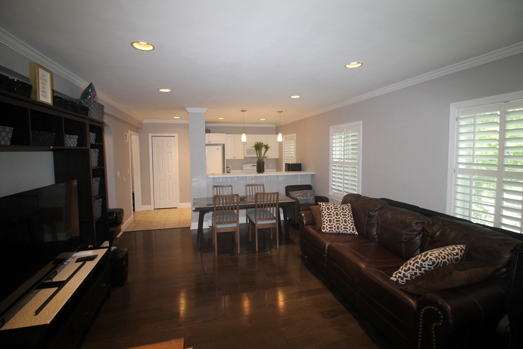 27 Commonwealth Avenue, Unit 1 Newton, MA 02467 - Photo 6 of 12 a living room with furniture and a flat screen tv