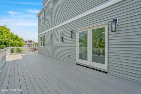 a view of a roof deck with wooden floor and fence