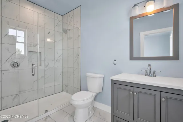 an empty room with window and ceiling fan