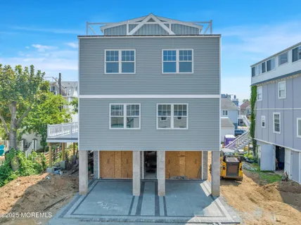 a large kitchen with kitchen island a sink stainless steel appliances and cabinets