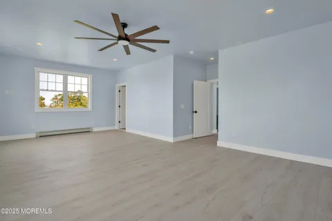 an empty room with a empty space and a ceiling fan